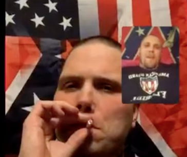 Screenshot of video chat between John Camden and Ramsey. Camden is larger and is smoking a cigarette in front of US flag superimposed with Confederate flag. Martin is in smaller window in front of a Confederate flag.