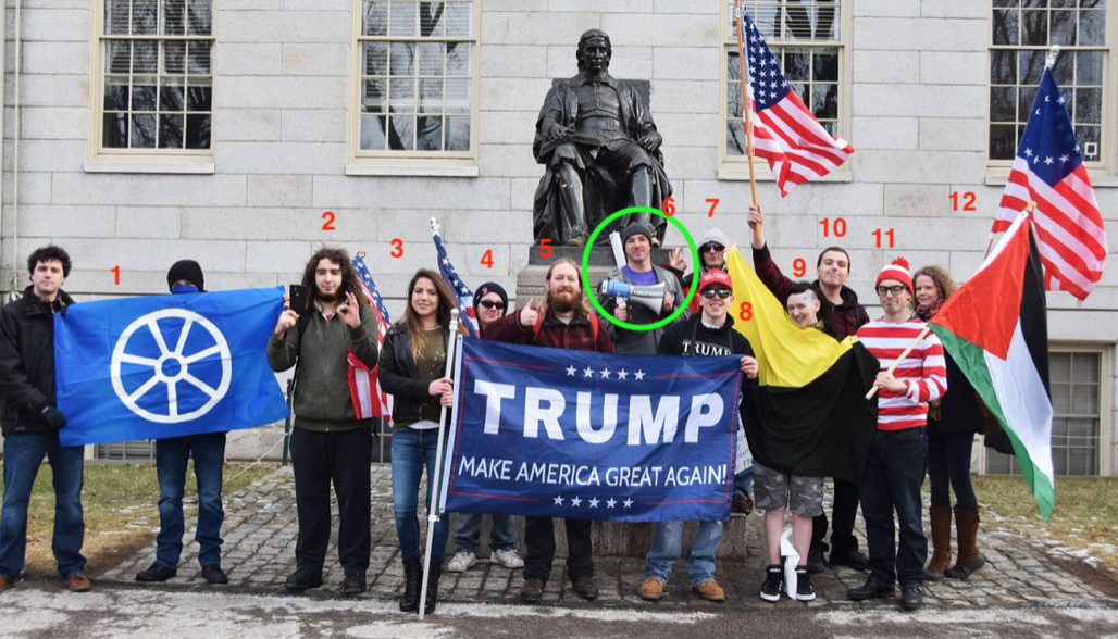 samson at a Resist Marxism action attempting to disrupt the Cambridge Women's march in 2018, he displays the ok sign surrounded by other people holding other white supremacist symbols