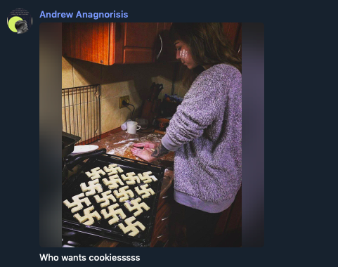 Photo of woman backing, a rack of swastika shaped cookies on the stove in front of her. She is looking away from the camera. The photo was posted by username Andrew Anagnorisis with the caption: "Who wants cookiessssss."