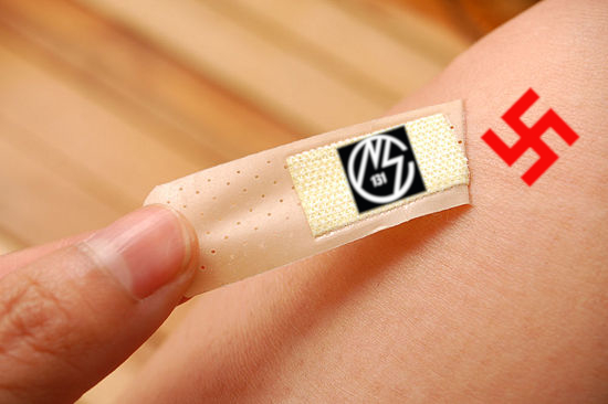 Image of a hand pulling off a bandaid - the NSC131 logo is on the inside padding of the bandaid, and the swastika symbol in red is where the bandaid used to be. 