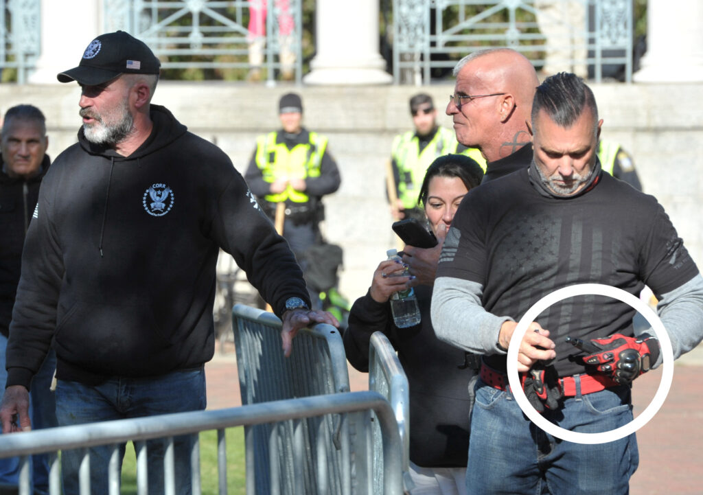 Photo of Steinhof walking with a CORR member who is holding an expandable baton.
